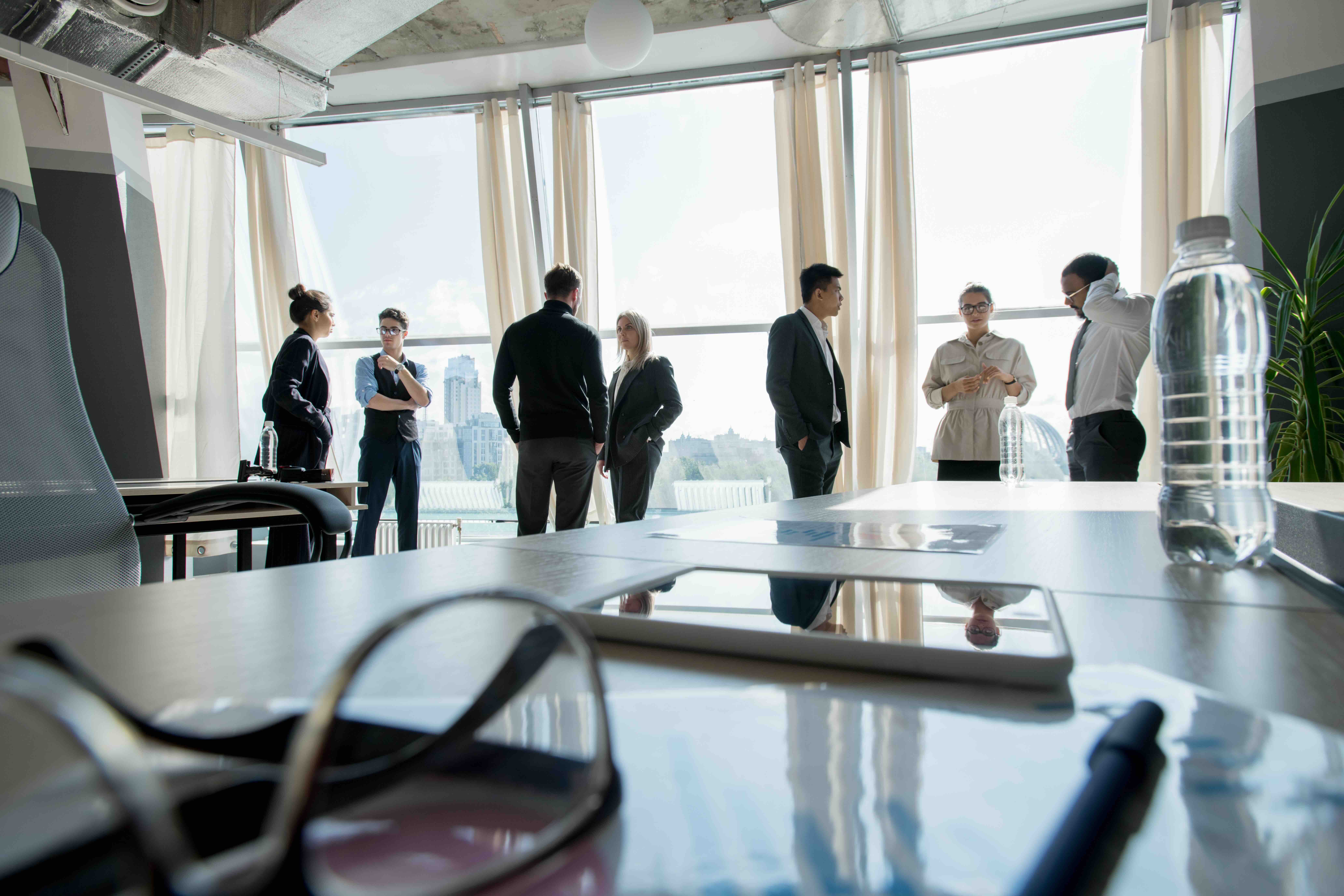 Workplace with business objects and touchpad with business group cooperating during break