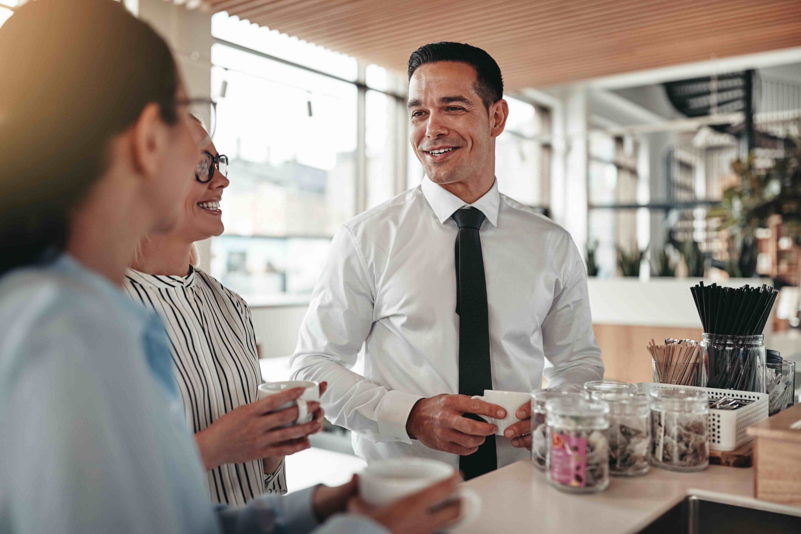 Small business team talking over coffee in a modern office